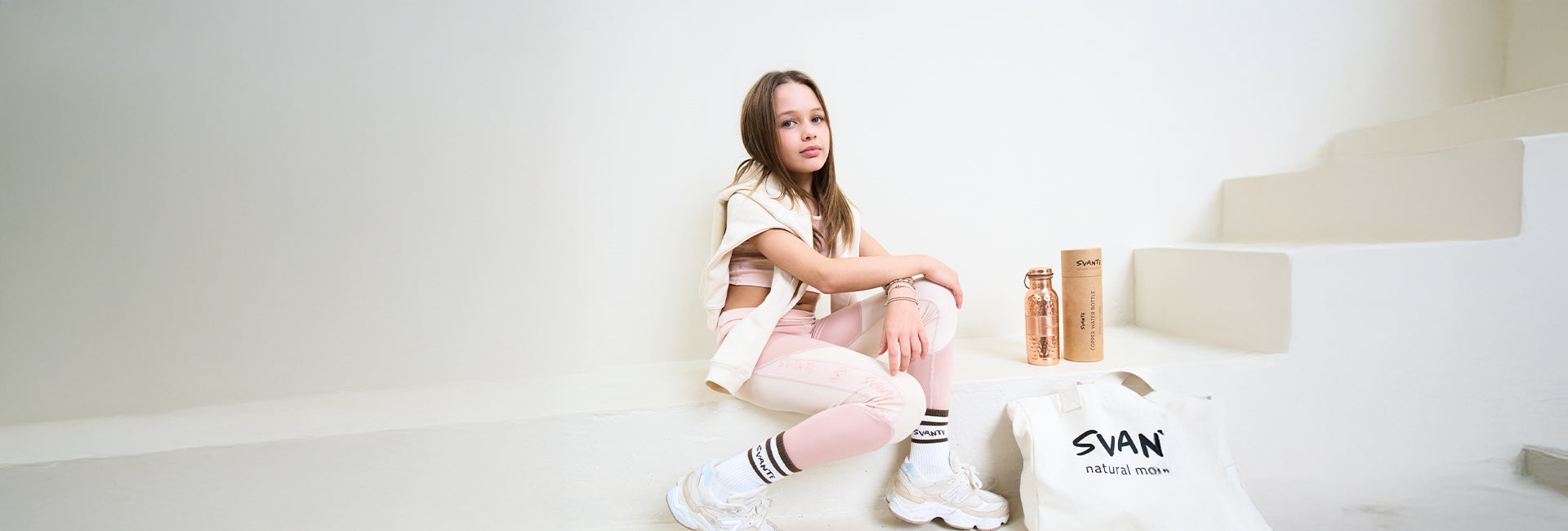 Girl aged 8 with tennis racket and wearing Svante floral natural material sports leggings and sports crop top that is toxin free and sustainable