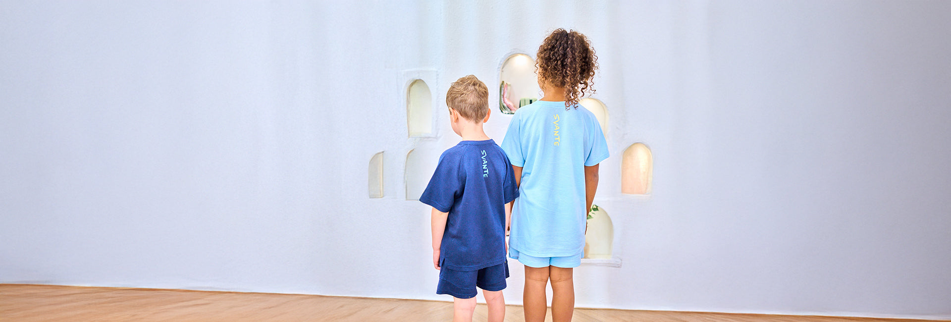 boy wearing sky blue colour Svante natural material sports shorts with Svante logo