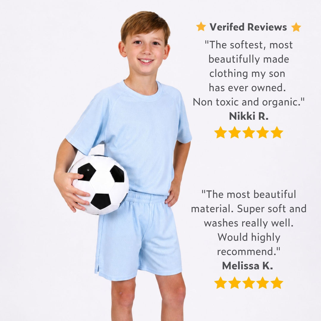 Boy wearing a Svante natural material sports shorts and T-shirt holding a soccer ball with five-star reviews displayed.
