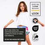 Young girl wearing a white organic cotton crop t shirt with Svante branding and certification logos on a white background. 