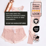 Pink children's natural material sports outfit with a copper water bottle, featuring certification logos and promotional text on a light grey background. 