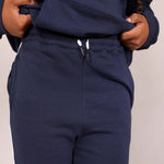 Close up of organic cotton navy blue joggers waist band and 'Svante' branded organic cotton draw strings with a plain background. 