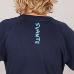 Close up image of Navy blue t-shirt with 'SVANTE' branding on the back, worn by a kid.